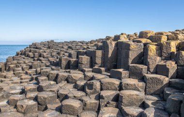 Mountain of hexagonal basalt columns of Giant's Causeway UNESCO World Heritage Site, is an area of about 40,000 interlocking , the result of an ancient volcanic fissure eruption. It is located in County Antrim on the north coast of Northern Ireland, 