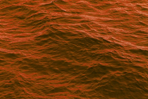 Оранжевый абстрактный фон волнистой поверхности воды — стоковое фото