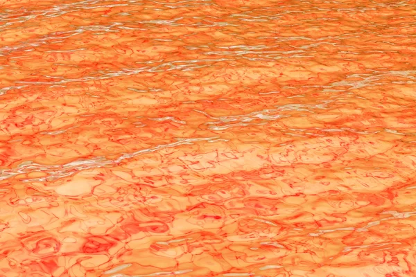 Orange abstrakter Hintergrund der welligen Wasseroberfläche — Stockfoto