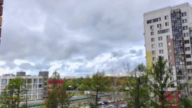 Timelapse of heavy clouds moving over city