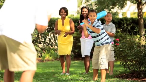 Madre y padre étnicos jugando béisbol con niños — Vídeos de Stock