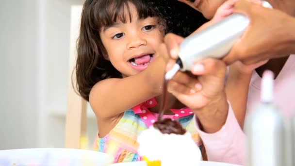 Little Ethnic Girl Young Mom Icing Cupcakes — Stock Video