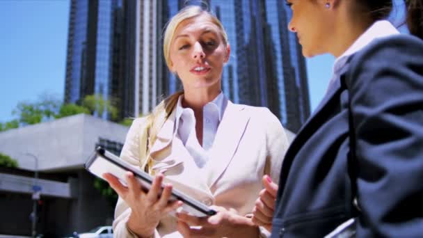 Female businesswomen using wireless tablet — Stock Video