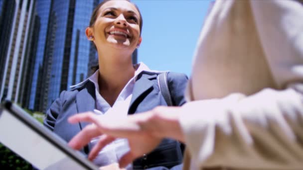 Female businesswomen using wireless tablet — Stock Video