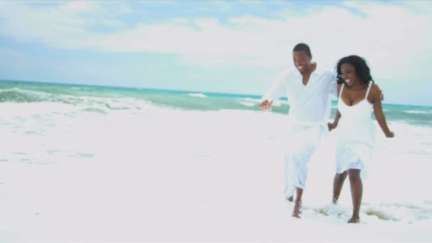 Etnica padre hija vestida de blanco disfrutando de tiempo caminando playa — Vídeo de stock