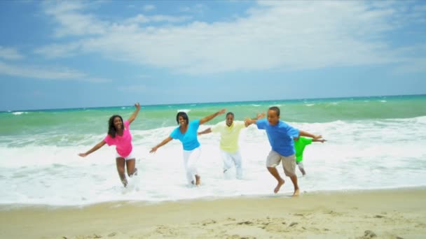 Ethnic family splashing in ocean surfs having fun together — Stock Video
