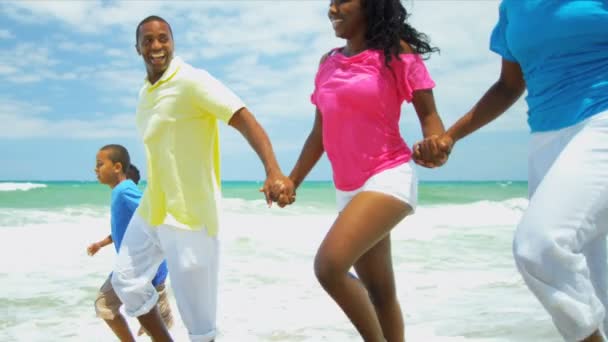 Summer time of African American family running in ocean surfs — Stock Video