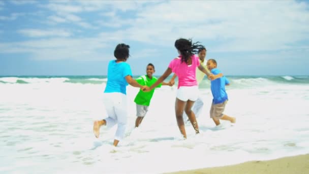 Diverse parents holding hands together sons and daughter enjoying beach — Stock Video