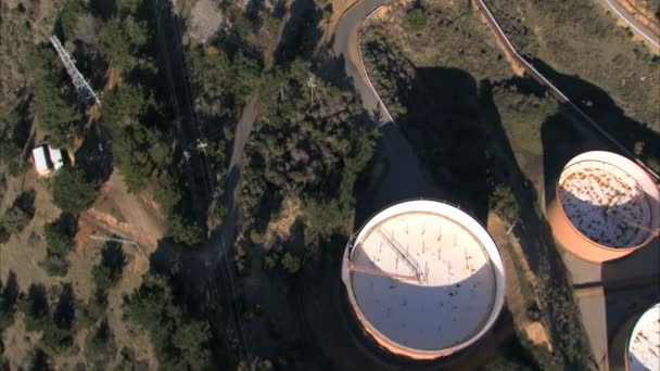 Aerial view of oil refinery tanks beside the ocean — Stock Video