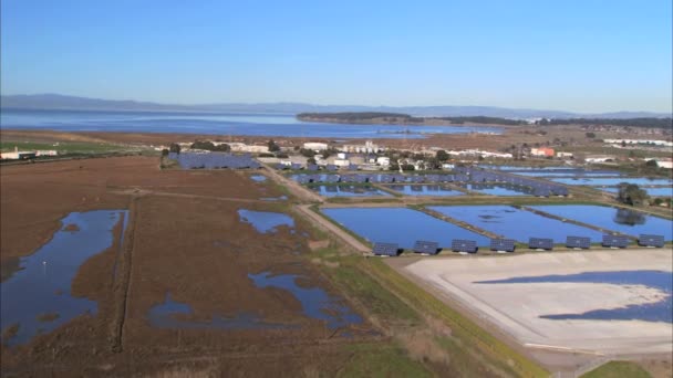 Вид с воздуха на солнечные батареи и завод — стоковое видео