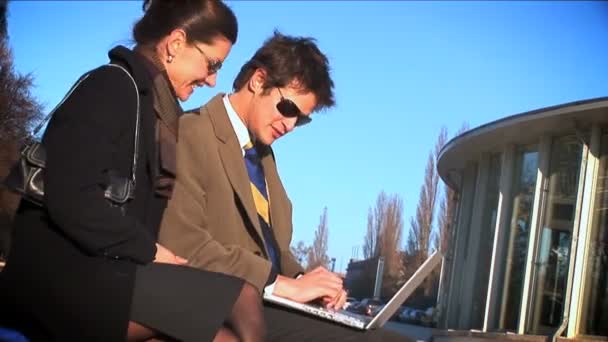 Wide shot of 2 businesspeople on laptop — Stock Video