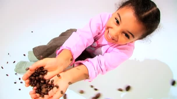 Little african american girl catching falling coffee beans — Stock Video