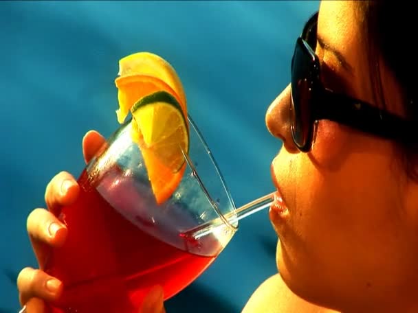 Gros plan d'une belle latino se relaxant avec un cocktail au bord de la piscine — Video