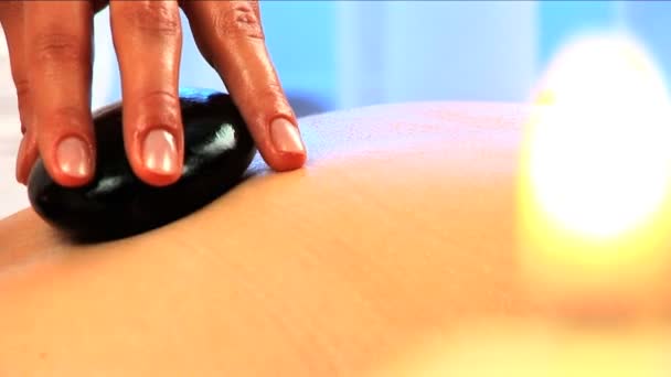 Beautiful blonde girl relaxing at health spa with candles burning — Stock Video