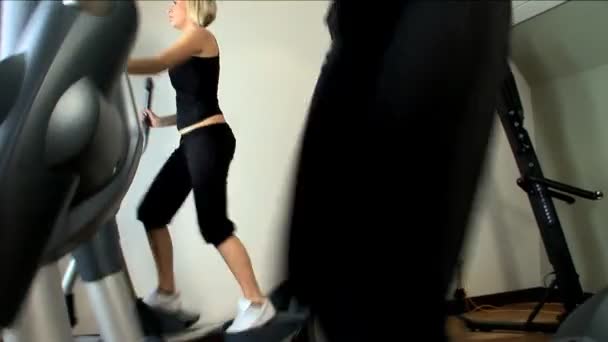 Beautiful blonde girls enjoy working out at the gym — Stock Video