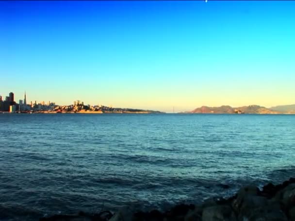 Distant pan shot of San Francisco & Golden Gate Bridge from the bay — Stock Video