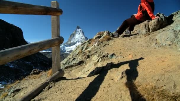 Female hiker enjoying view of the Matterhorn — Stock Video