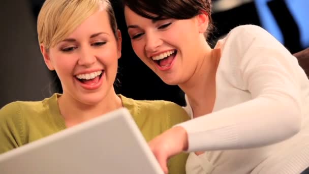 Pretty friends having fun using a laptop computer — Stock Video