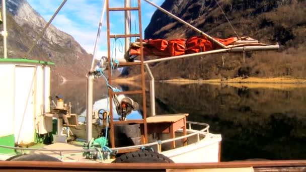 Fishing boat moored on mirror clear water of glacial fjord — Stock Video