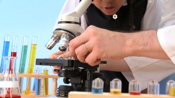 Cute african american schoolgirl with teacher learning elementary science — Stock Video