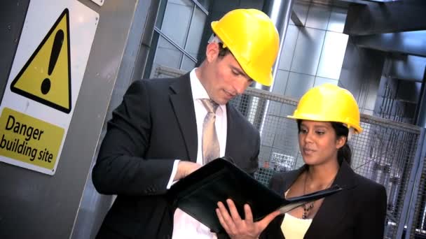 Young graduate engineers with modern city construction plans — Stock Video