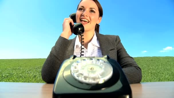 Concept shot of young businesswoman in city clothes using old-fashioned telephone — Stock Video