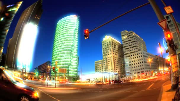 Wide angle shot of modern city skyscrapers lit at night & with time-lapse traffic — Stock Video