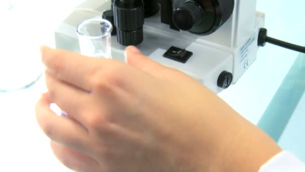 Close up of a researcher looking through a microscope — Stock Video