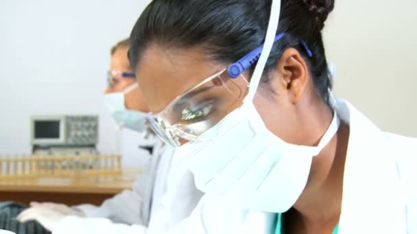 Close up of female scientist examines a test tube — Stock Video