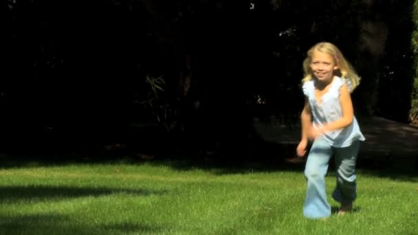 Pretty little blonde girl having fun outdoors on a summers day — Stock Video