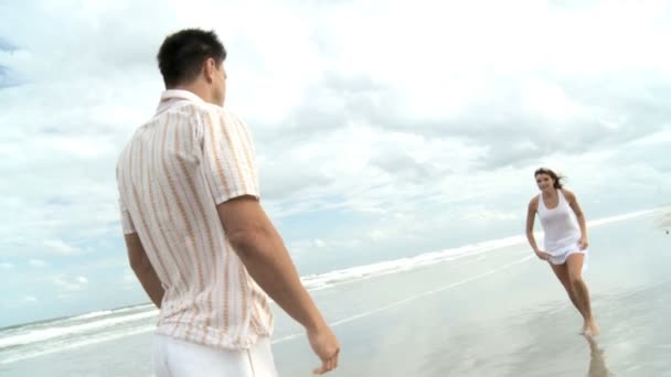 Two young in love having crazy fun on the beach — Stock Video