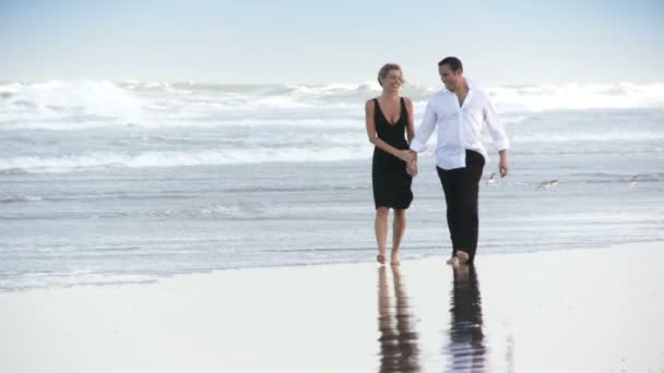 Two young in love having fun on the beach early morning after a social night out — Stock Video