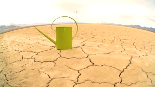 Concept shot of watering can on baked dry earth — Stock Video