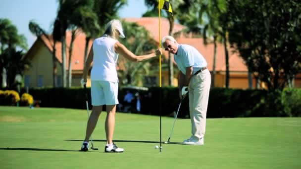 Adultos mayores saludables disfrutando del golf — Vídeo de stock