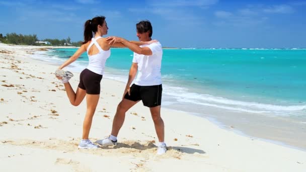 Couple Exercising on the Beach — Stock Video