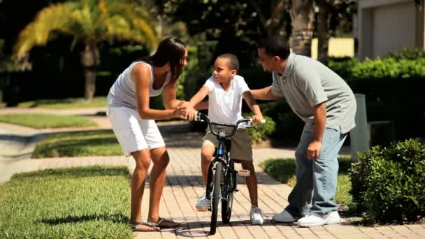 Jeune garçon ethnique pratiquant l'équitation à vélo — Video