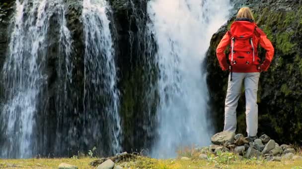 Senderista que se detiene en la cascada — Vídeo de stock