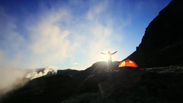 Female Celebrating Dawn Outside Expedition Tent — Stock Video