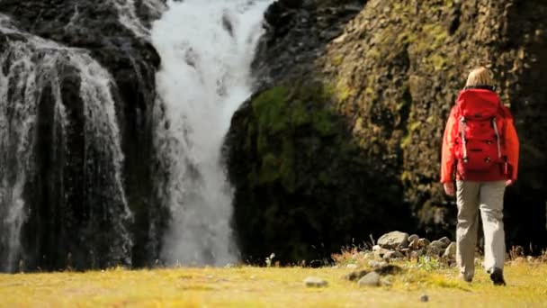 Female Hiker Reaching a Glacial Waterfall — Stock Video