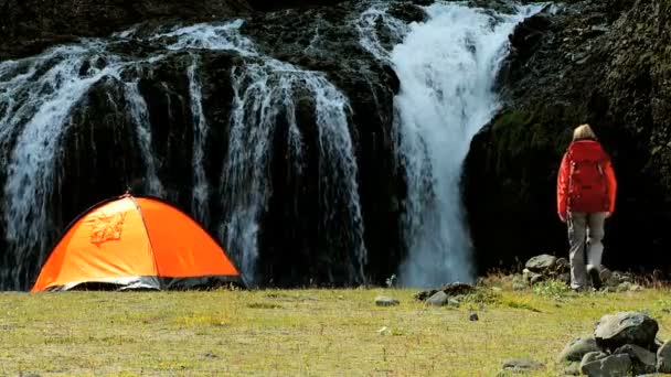 Einsame Wanderin im Zelt am Wasserfall — Stockvideo