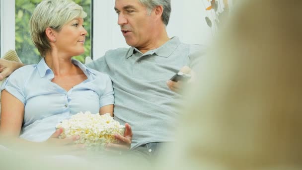 Mature Caucasian Couple Enjoying TV & Popcorn — Stock Video