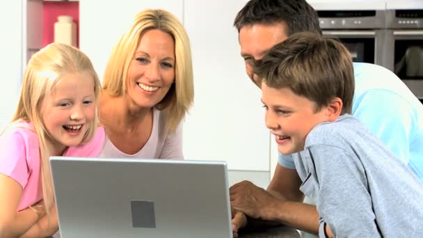 Familia joven caucásica usando computadora portátil — Vídeo de stock