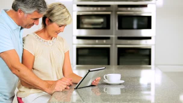 Caucasian Couple in Home Kitchen Using Wireless Tablet — Stock Video