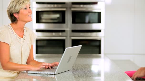 Wireless Laptop Used by Mature Couple in Kitchen — Stock Video