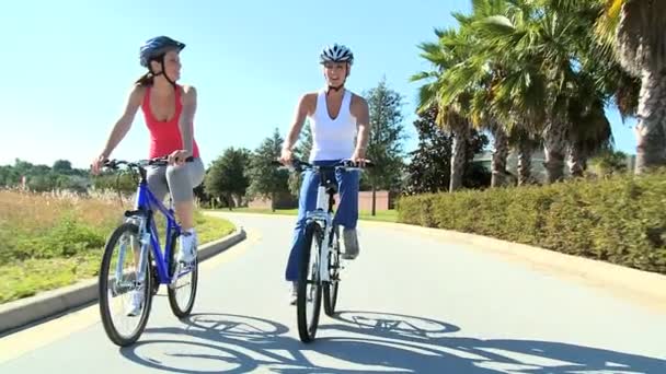 Young Females Keeping Fit and Healthy Cycling — Stock Video