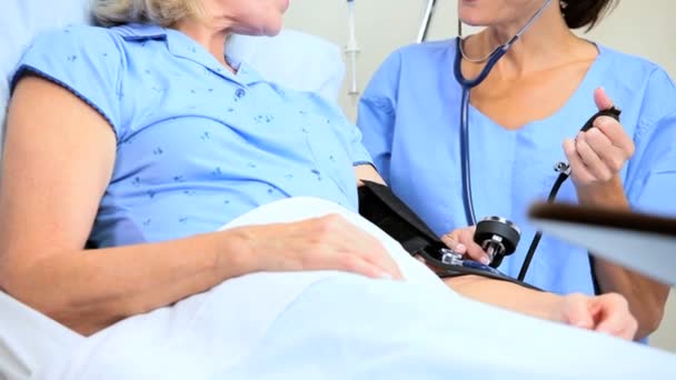 Hospital Staff Treating Senior Female Patient — Stock Video