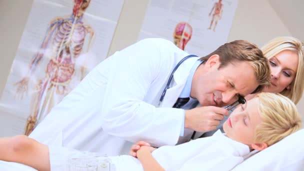 Male Doctor Diagnosing Little Boy on Hospital Ward — Stock Video