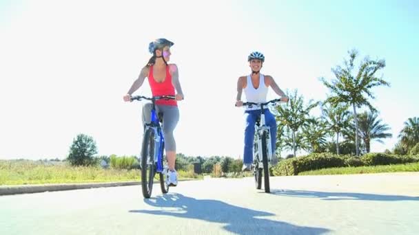 Young Females Keeping Fit and Healthy Cycling — Stock Video