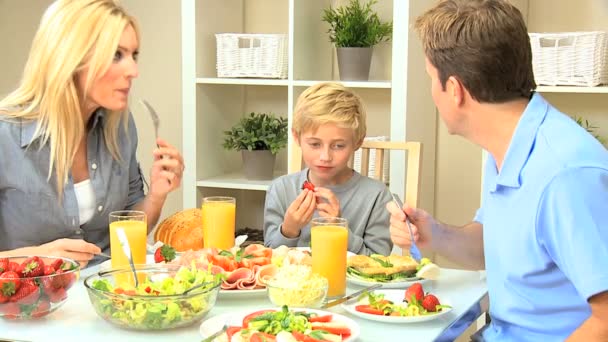 Familia joven caucásica comiendo juntos un almuerzo saludable — Vídeo de stock