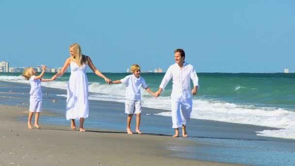 Família caucasiana feliz desfrutando de férias na praia — Vídeo de Stock